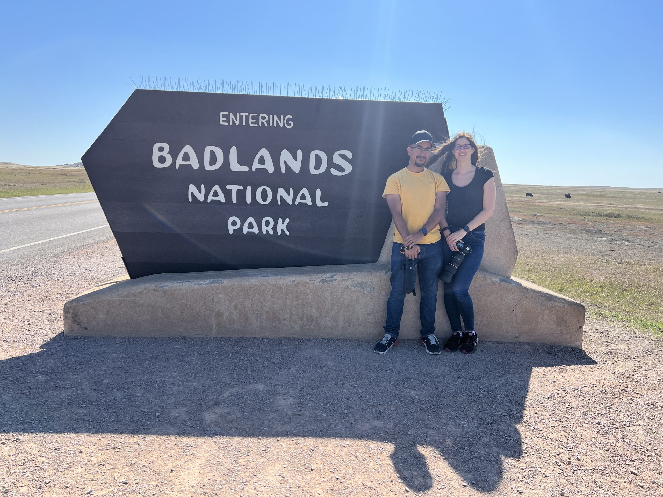 Danielle & Lucio in front of the Badlands National Park sign